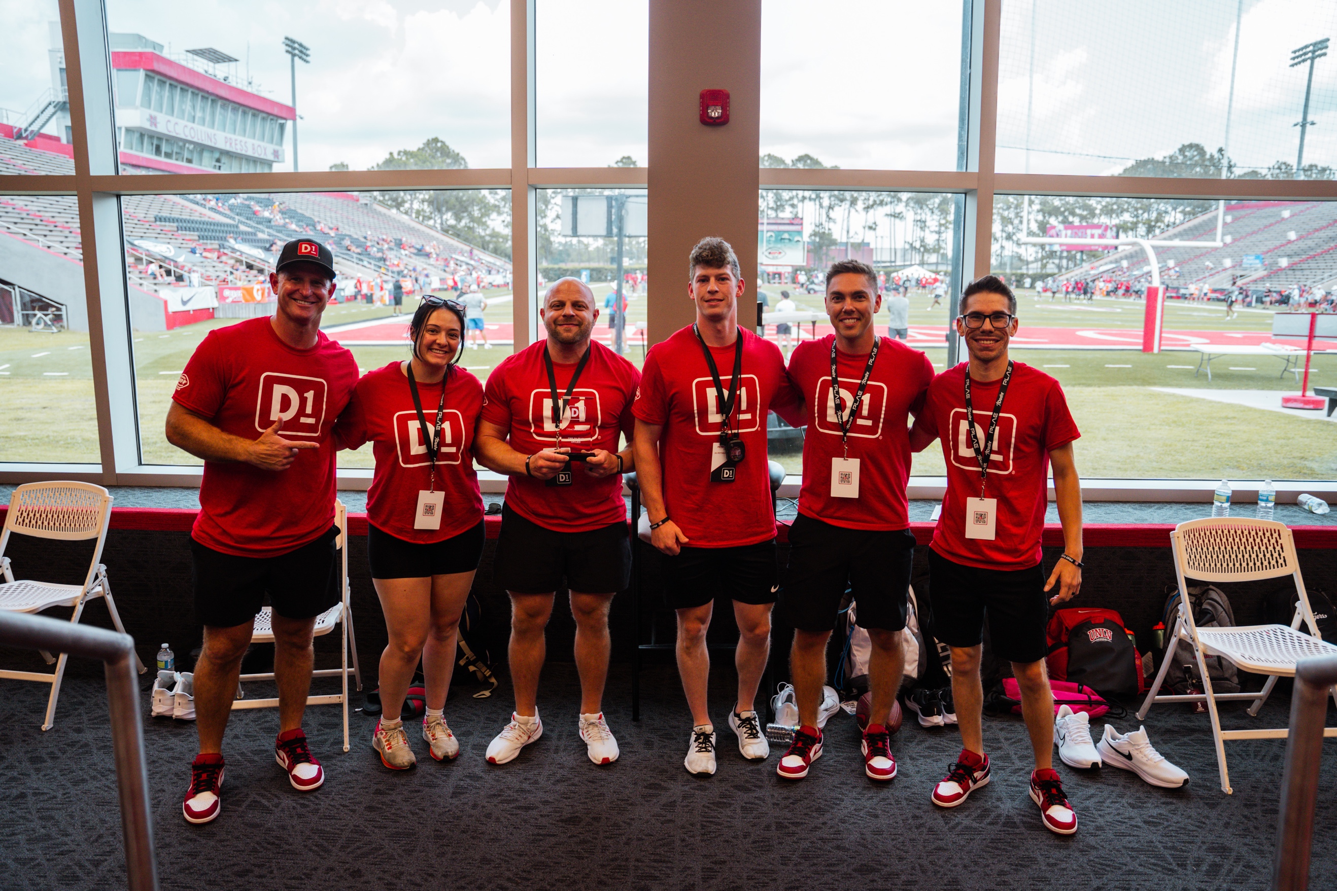 A group of people wearing matching red shirts

Description automatically generated