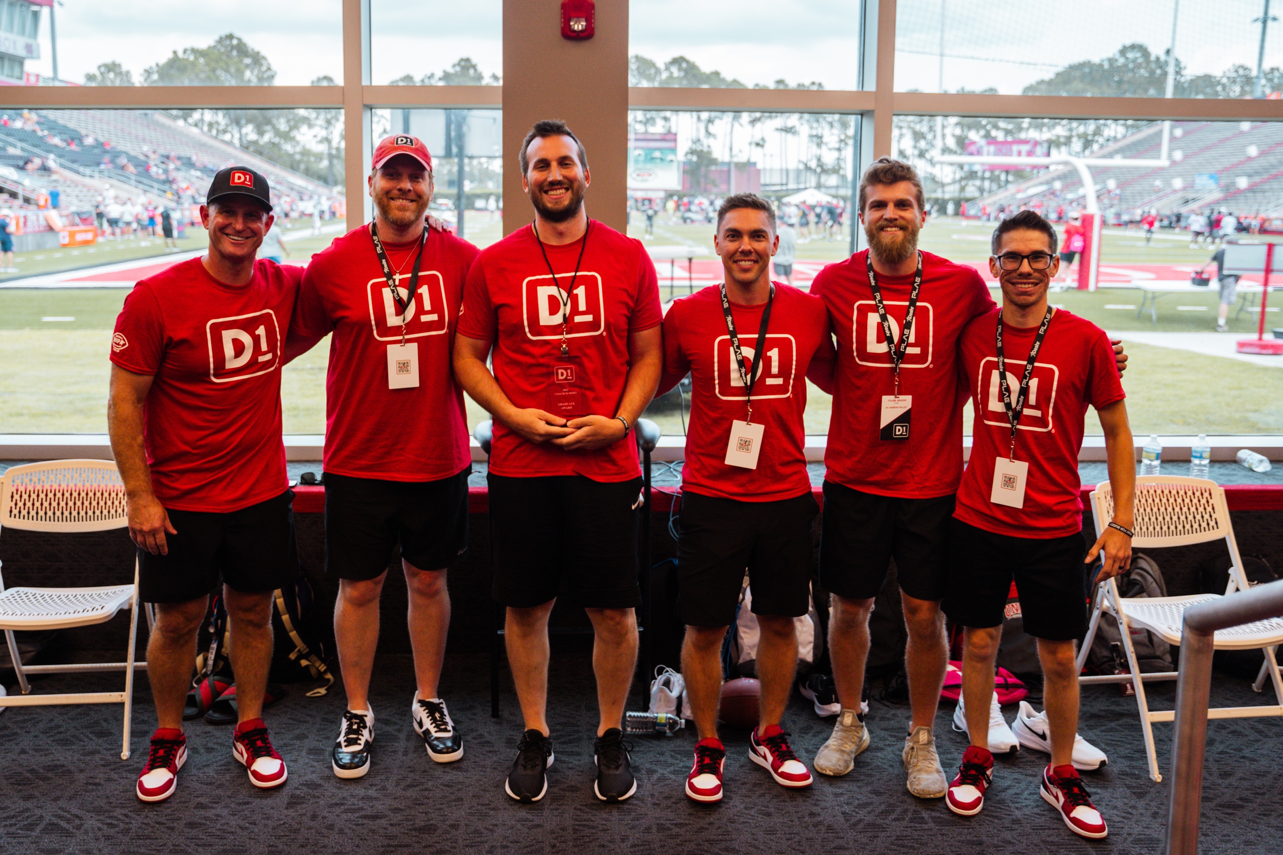 A group of men wearing red shirts

Description automatically generated