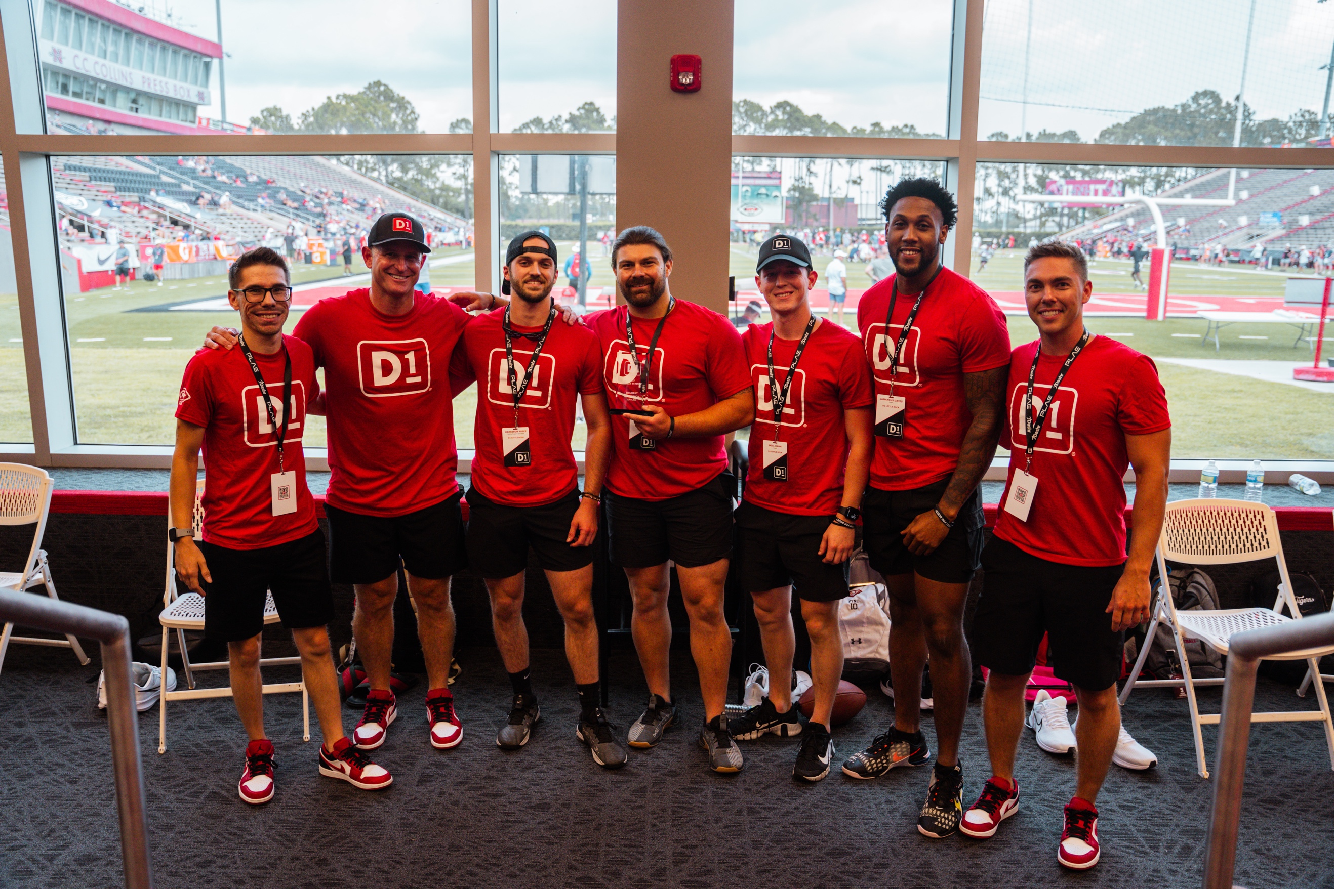 A group of men wearing red shirts

Description automatically generated