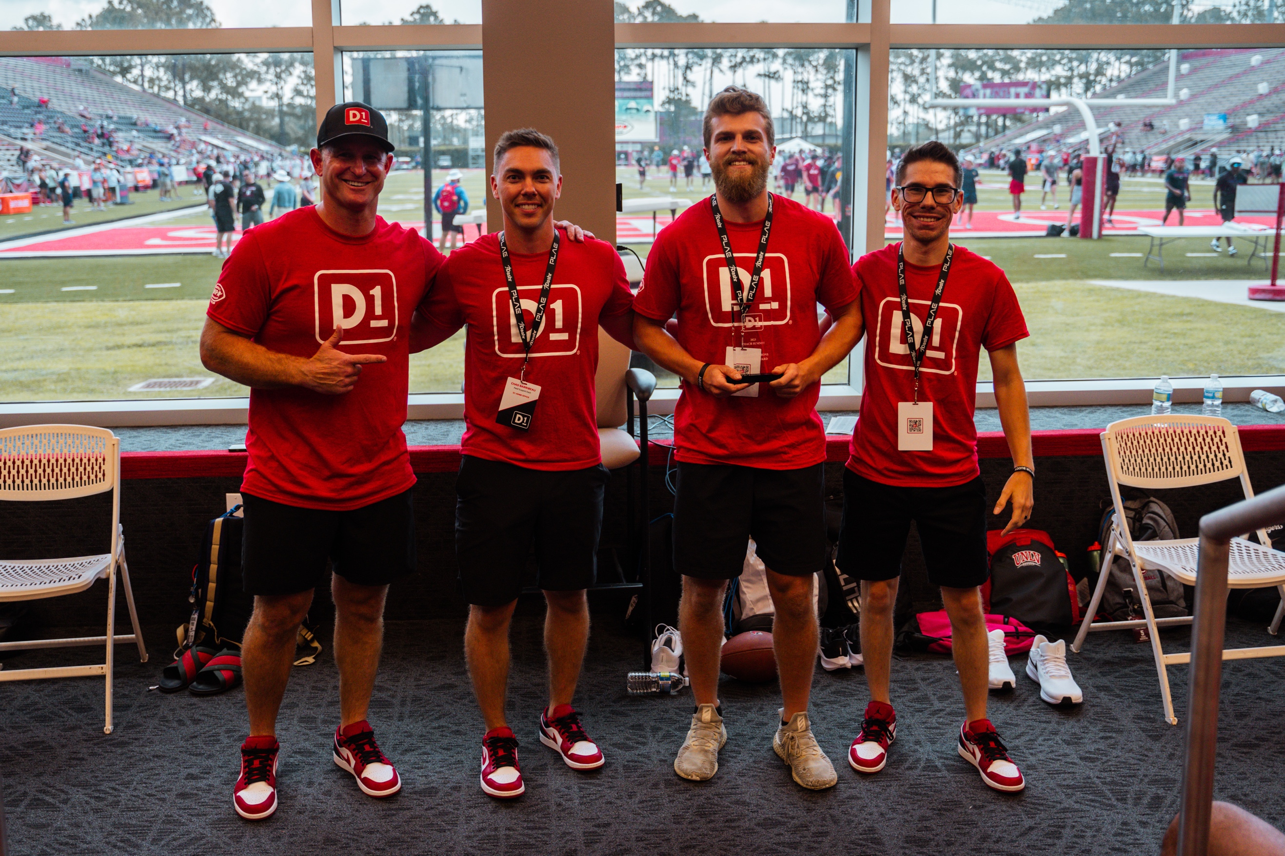 A group of men wearing red shirts

Description automatically generated