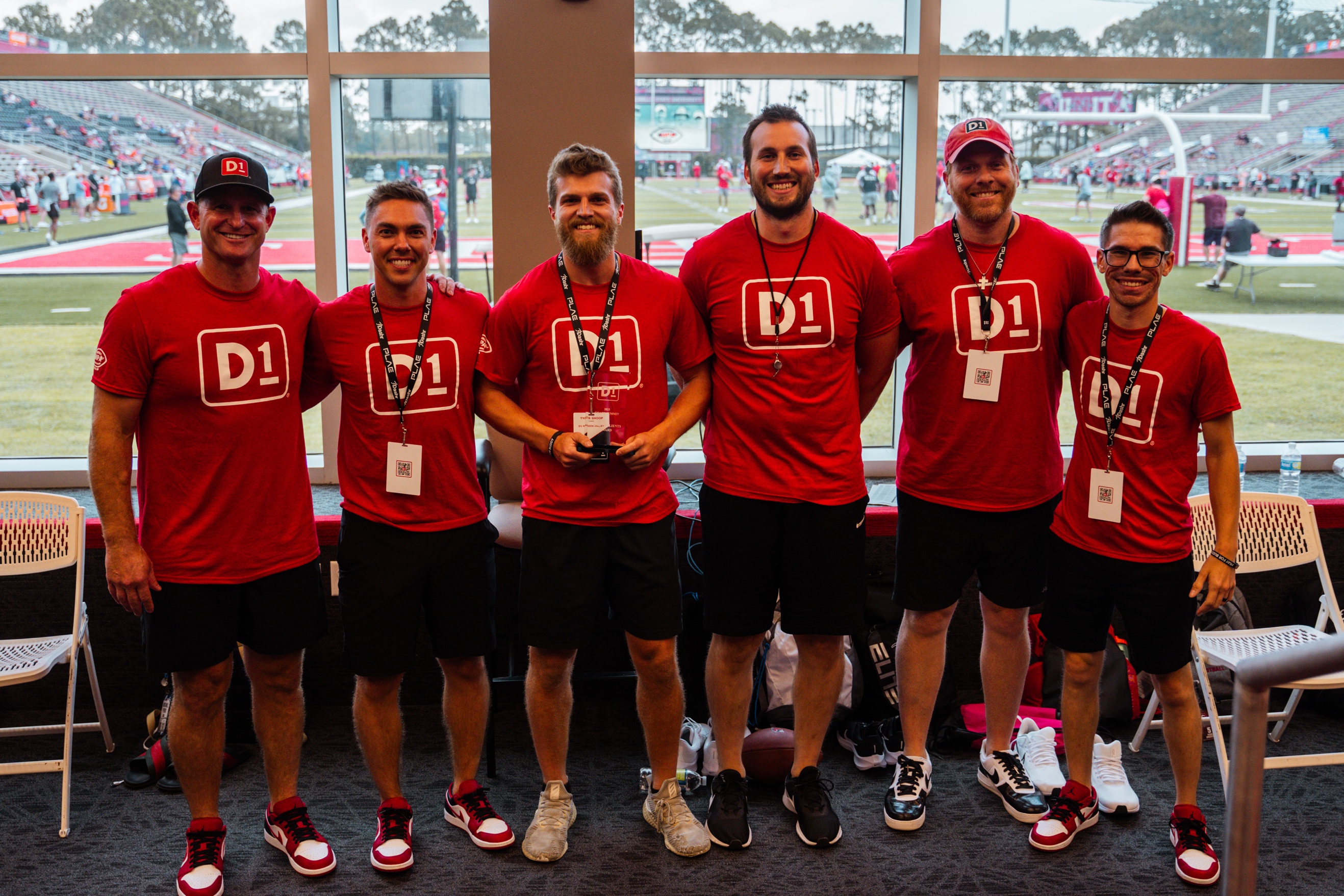 A group of men wearing red shirts

Description automatically generated