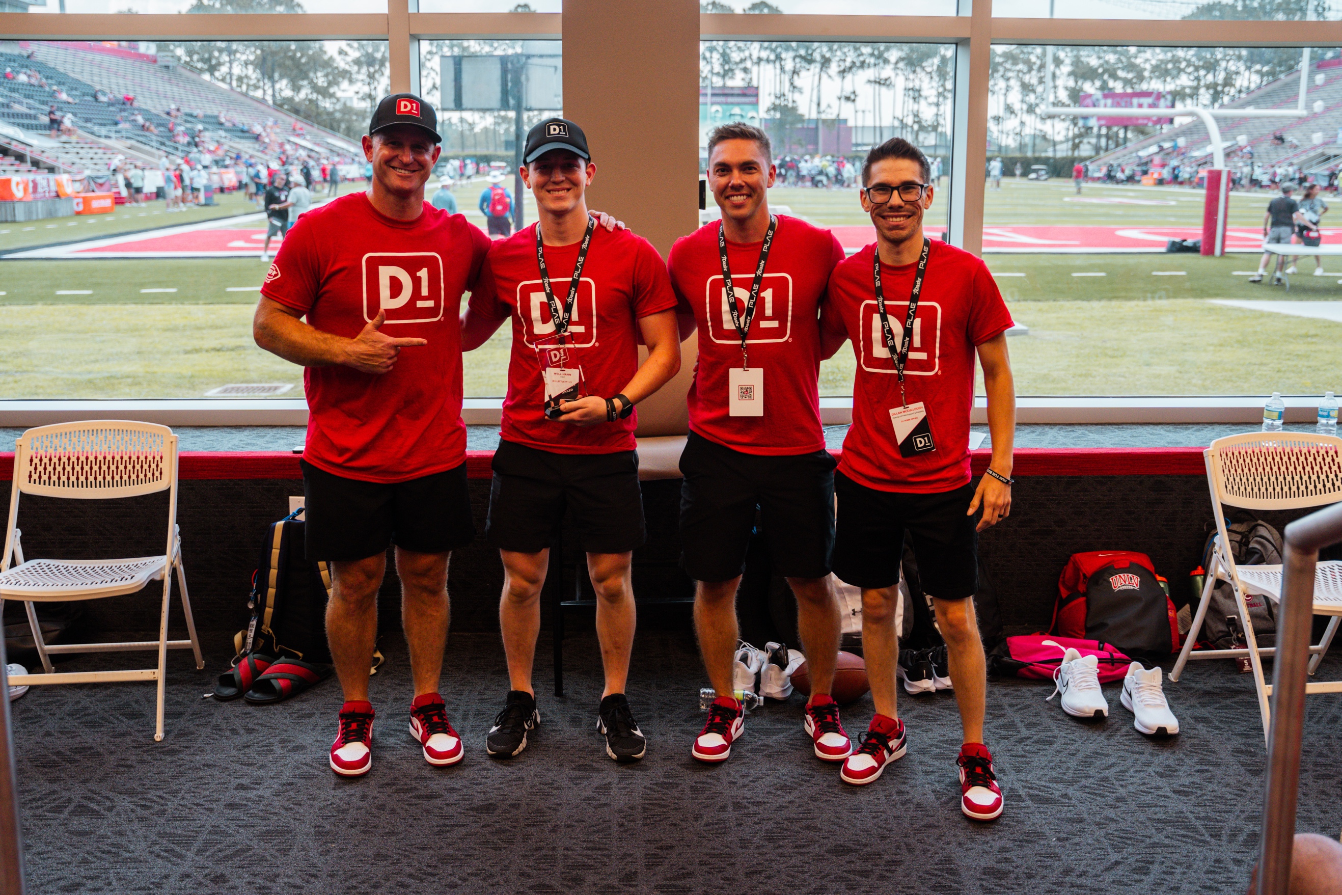 A group of men wearing matching red shirts

Description automatically generated