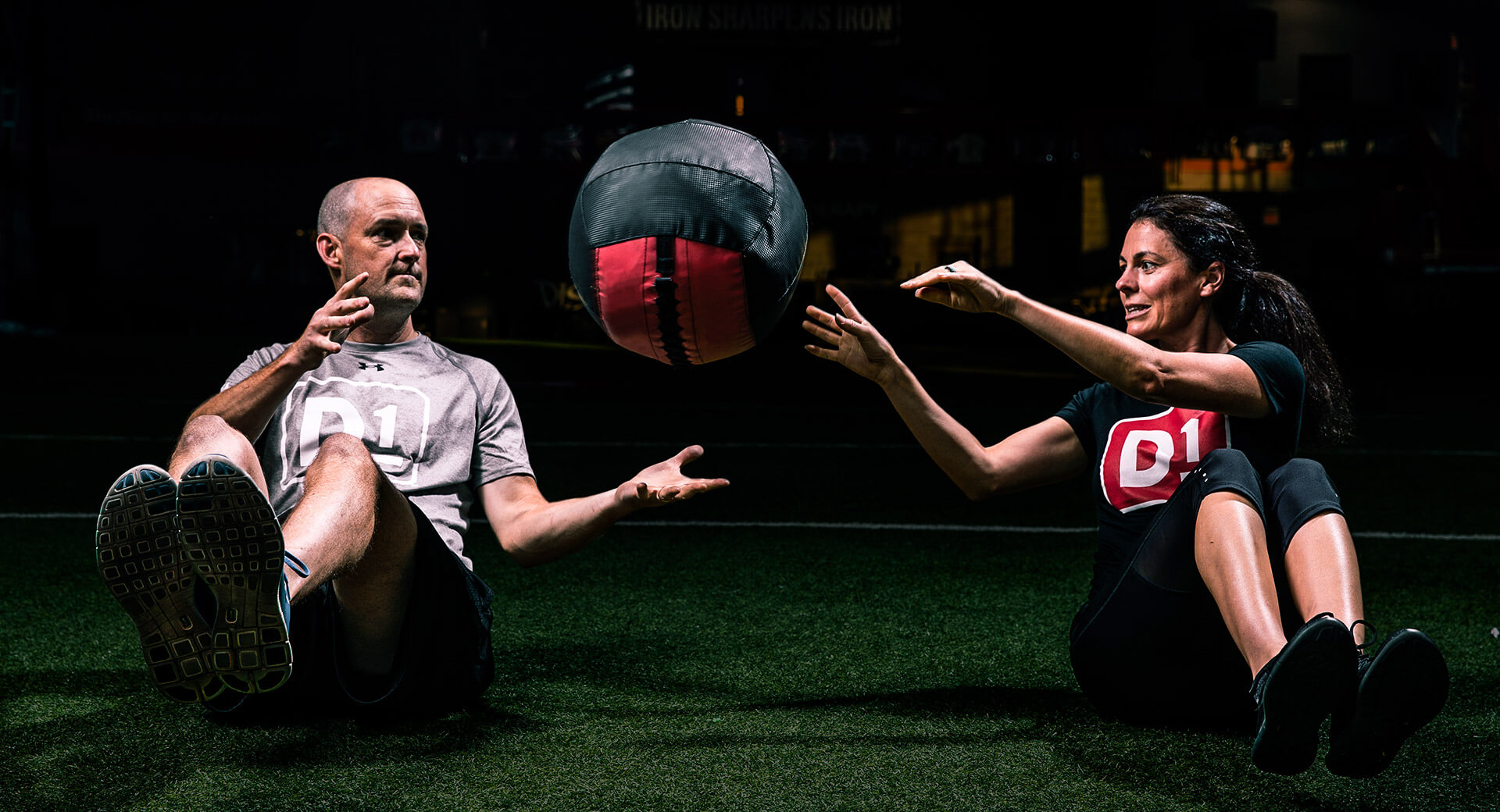 Fitness gym members working out with a medicine ball