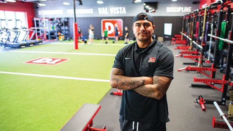 man in gym with arms crossed