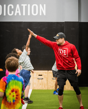 man highfiving kid