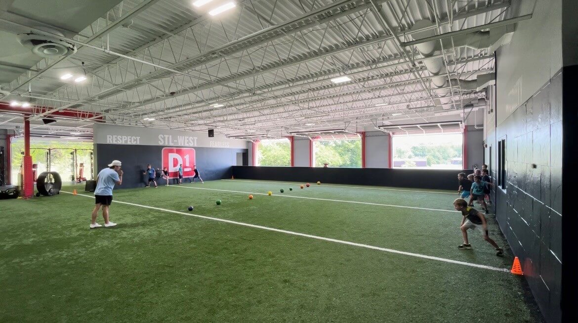 Kids lined up against a wall ready to race at D1 Training St. Louis West