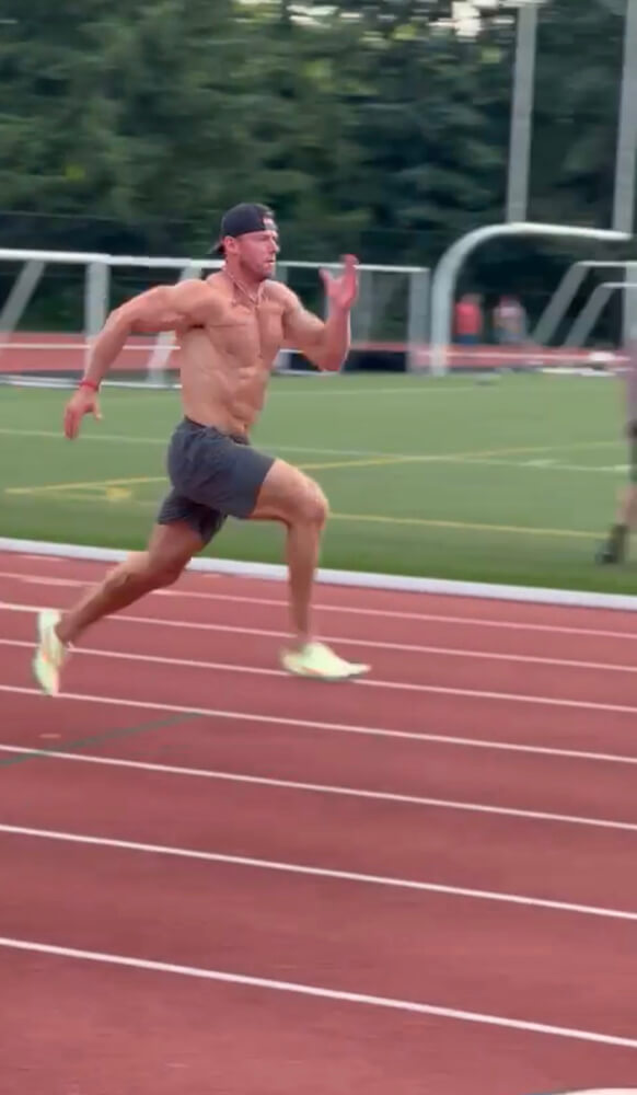 athletic man running on track field